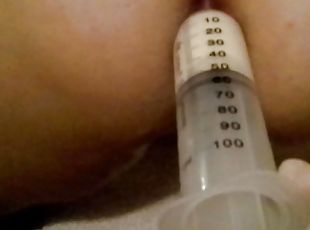 2 Warm milk enema syringes and anal inspection