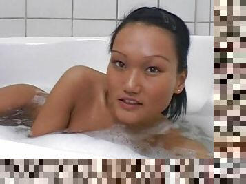 Sweet Asian solo in the warm tub