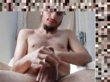 Solo hairy boy ( faggot twink jerking off his cock seated in a chair next to his windows