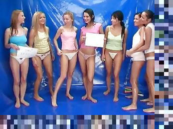 Seven naked teens play with a set of dildos