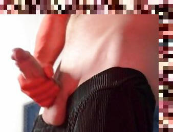 man masturbates shaved cock in red gloves