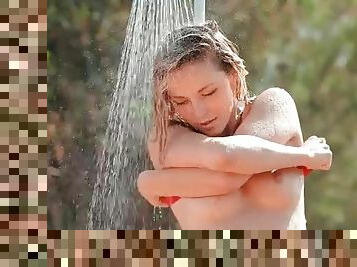 Slender leggy beauty takes sexy shower outdoors