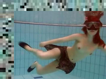 Beautiful slender teen filmed swimming underwater