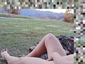 Hot outdours. Naked girl in nature. Fire and mountains