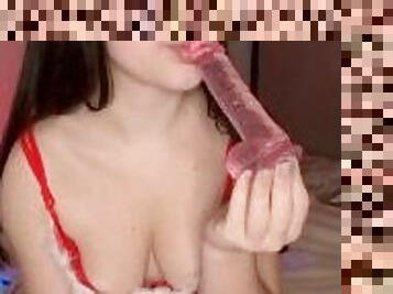 brunette sucks a dildo in Christmas lingerie