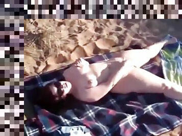 Mom Jenny masturbates on a public beach