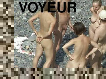 Voyeur watching nude babes at the beach