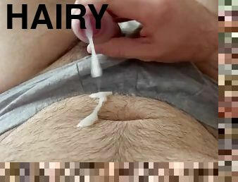 Hairy man shoots huge slugs of cum on himself