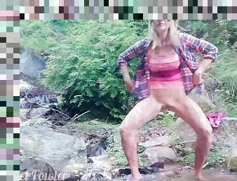 Exhibitionist teenage peeing and taking shower in the Waterfall river