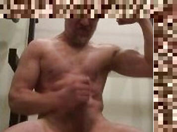 Bodybuilder straining muscles producing loads of precum, foot worship, flexing and cum!