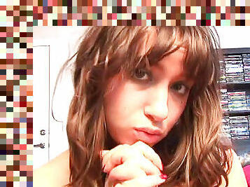 Amateur brunette is sucking her fingers on the webcam