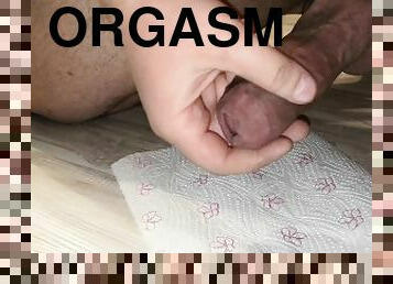 I play with a big cock and cum on a napkin. Close-up.