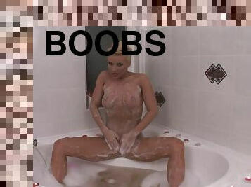 Gorgeous blonde bitch soaps herself up in the bathtub
