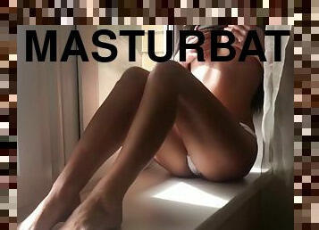 Sensual masturbation in front of the window
