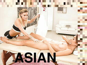 Blonde masseuse plays with Asian clients pussy