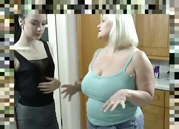GILF with big tits sensually fucks a younger girl in the kitchen