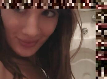 Gorgeous brunette records herself in the bathroom mirror