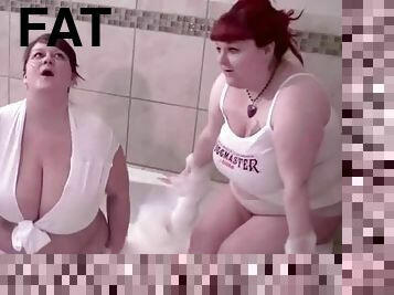 Two chunky redhead babes play in the bathtub