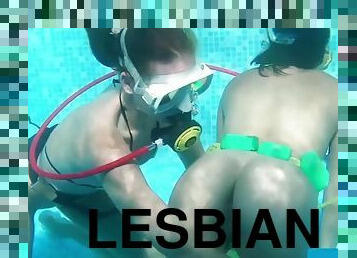 Two hot lesbians play with dildos in the pool
