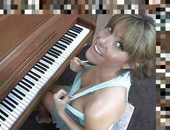 Sexy blonde Talia is playing on piano