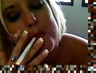 She smokes her cigarette and gives a BJ