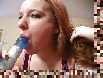 Redhead blows a dildo and talks naughty