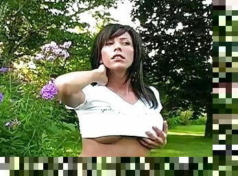 Sexy brunette Mya is posing topless in the park