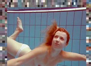 In The Indoor Pool, A Stunning Girl Swims