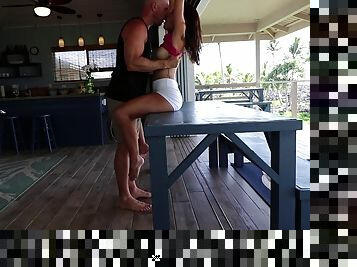 Passionate couple doing it on the backyard table