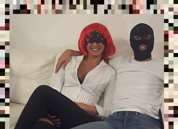 Gal in a vibrant red wig and a masked man do it up in style