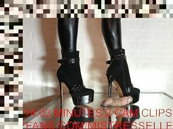 Mistress Elle wearing her studded boots grinds her slave's cock