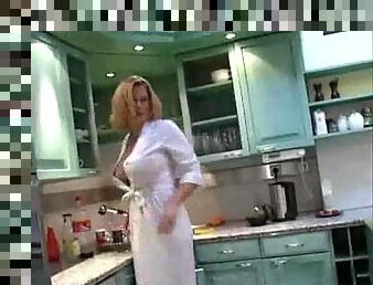 Busty chick in a satin robe in the kitchen