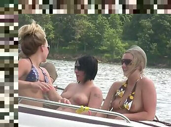 Nasty amateur girls sitting in a boat flash their boobs